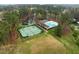 An aerial view showing a community with a swimming pool, tennis court, and green spaces at 1188 The Preserve Trl, Chapel Hill, NC 27517