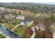 A picturesque aerial view of several homes in a quiet neighborhood with mature trees and green lawns at 1188 The Preserve Trl, Chapel Hill, NC 27517