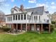 Admire the rear exterior of this home, featuring a beautiful backyard with a blend of patio spaces and lush green lawn at 1188 The Preserve Trl, Chapel Hill, NC 27517