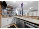 Finished basement bar area with white cabinets, granite countertops, and an adjacent recreation space at 1188 The Preserve Trl, Chapel Hill, NC 27517