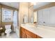 Bathroom with a shower-tub combo, cream walls, and wood vanity at 1188 The Preserve Trl, Chapel Hill, NC 27517
