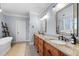 Bright bathroom featuring a double vanity with granite countertops and modern fixtures at 1188 The Preserve Trl, Chapel Hill, NC 27517