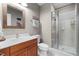 Bathroom featuring a vanity with a sink, framed mirror, toilet, and glass-enclosed shower stall at 1188 The Preserve Trl, Chapel Hill, NC 27517