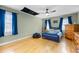 Bedroom with blue walls, wood floors, ceiling fan, and two large windows at 1188 The Preserve Trl, Chapel Hill, NC 27517