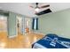 Bedroom features green walls, walk-in closet, wood floors, and blue curtains at 1188 The Preserve Trl, Chapel Hill, NC 27517