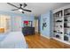 Bedroom with hardwood floors, ceiling fan, dresser, and panda decorations at 1188 The Preserve Trl, Chapel Hill, NC 27517