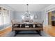Formal dining room with rustic wood table, woven chairs, and elegant chandelier at 1188 The Preserve Trl, Chapel Hill, NC 27517