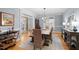 Elegant dining room featuring a rustic wood table, woven chairs, hardwood floors, and natural light at 1188 The Preserve Trl, Chapel Hill, NC 27517
