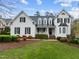 Charming two-story white home featuring a well-manicured lawn, black shutters, and a welcoming front porch at 1188 The Preserve Trl, Chapel Hill, NC 27517