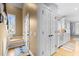 Inviting foyer featuring hardwood floors, staircase and a glimpse of a modern, all-white kitchen at 1188 The Preserve Trl, Chapel Hill, NC 27517