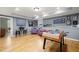 Spacious recreation area with hardwood floors and adjacent game room area with a foosball table at 1188 The Preserve Trl, Chapel Hill, NC 27517