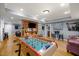 Recreation area with a foosball table, hardwood floors, and an adjacent living space at 1188 The Preserve Trl, Chapel Hill, NC 27517