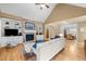 Bright living room featuring a stone fireplace, hardwood floors, built-in shelves, and comfortable seating at 1188 The Preserve Trl, Chapel Hill, NC 27517