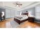 Cozy bedroom with plenty of natural light, hardwood floors, and a ceiling fan at 1188 The Preserve Trl, Chapel Hill, NC 27517