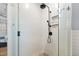 Modern shower with white subway tile, river rock floor, and matte black fixtures at 1188 The Preserve Trl, Chapel Hill, NC 27517