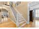 Interior view of the staircase with hardwood floors and black iron railings at 1188 The Preserve Trl, Chapel Hill, NC 27517