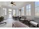 Charming sunroom with lots of natural light, comfortable seating, and a ceiling fan at 1188 The Preserve Trl, Chapel Hill, NC 27517