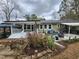 Well-maintained backyard featuring a covered patio, ample seating, and landscaped garden beds at 1209 Mill Valley Rd, Fuquay Varina, NC 27526