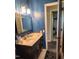 Bathroom showcasing elegant vanity, gold fixtures, and a decorative mirror at 1209 Mill Valley Rd, Fuquay Varina, NC 27526