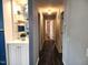 Hallway featuring hardwood floors, custom shelving, and stylish lighting at 1209 Mill Valley Rd, Fuquay Varina, NC 27526