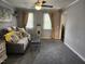 Cozy living room featuring plush seating, neutral tones, and plenty of natural light at 1209 Mill Valley Rd, Fuquay Varina, NC 27526