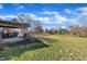 Large backyard featuring well-maintained lawn, mature trees, and a pergola-covered patio area at 1220 Bethlehem Rd, Knightdale, NC 27545