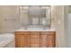 Bathroom featuring a double sink vanity, framed mirror, and adjacent soaking tub at 1220 Bethlehem Rd, Knightdale, NC 27545