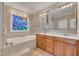 Relaxing bathroom with a soaking tub, stained glass window, and double sink vanity at 1220 Bethlehem Rd, Knightdale, NC 27545