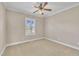 Bedroom featuring neutral carpet, ceiling fan and a large window at 1220 Bethlehem Rd, Knightdale, NC 27545
