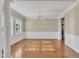 Formal dining room featuring hardwood floors, large windows and decorative chandelier at 1220 Bethlehem Rd, Knightdale, NC 27545