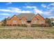 Classic brick home with white windows, complemented by manicured shrubs and a lush lawn, offering great curb appeal at 1220 Bethlehem Rd, Knightdale, NC 27545