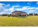 Expansive backyard featuring lush green grass and mature trees surrounding brick home at 1220 Bethlehem Rd, Knightdale, NC 27545