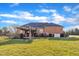 Brick home exterior showcasing a well-kept lawn and a pergola covered patio at 1220 Bethlehem Rd, Knightdale, NC 27545