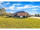 Exterior home view showing a large yard, generator, brick and pergola covered patio at 1220 Bethlehem Rd, Knightdale, NC 27545