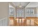 Elegant foyer with hardwood floors, chandelier, stained glass door, and white trim for a grand entrance at 1220 Bethlehem Rd, Knightdale, NC 27545