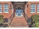 Close-up view of the brick entrance with a beautiful front door and decorative sconces at 1220 Bethlehem Rd, Knightdale, NC 27545