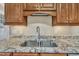 Close up of kitchen sink with granite countertops and custom cabinets at 1220 Bethlehem Rd, Knightdale, NC 27545
