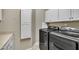 Modern laundry room featuring a front load washer and dryer, and ample cabinet space at 1220 Bethlehem Rd, Knightdale, NC 27545