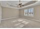 A main bedroom with neutral carpet, tray ceiling, and two windows offering natural light at 1220 Bethlehem Rd, Knightdale, NC 27545
