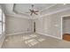 An inviting main bedroom with a tray ceiling and soft carpet, illuminated by sunlight streaming through the windows at 1220 Bethlehem Rd, Knightdale, NC 27545