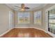 Bright room with hardwood floors, big windows, and a decorative ceiling fan at 1220 Bethlehem Rd, Knightdale, NC 27545