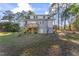 Spacious backyard featuring a two-story home with a wooden deck and stairs at 123 E Weatherspoon St, Sanford, NC 27330
