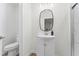 Clean bathroom with white vanity, modern fixtures, and sleek oval mirror at 123 E Weatherspoon St, Sanford, NC 27330