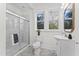 Bathroom featuring glass enclosed shower, modern fixtures and a large window at 123 E Weatherspoon St, Sanford, NC 27330