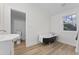 Bright bathroom featuring a vintage clawfoot tub, modern vanity, and stylish flooring at 123 E Weatherspoon St, Sanford, NC 27330