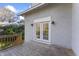Back deck features French doors, wooden railing, and outdoor lighting fixtures at 123 E Weatherspoon St, Sanford, NC 27330