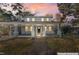 Beautiful two-story home with a covered porch, highlighted by a colorful sunset sky at 123 E Weatherspoon St, Sanford, NC 27330