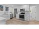 Renovated kitchen with white cabinets, stainless steel appliances, and stylish flooring at 123 E Weatherspoon St, Sanford, NC 27330