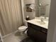 Well-lit bathroom featuring a vanity with storage, a large mirror, and tiled floors at 12409 Angel Vale Pl, Durham, NC 27703