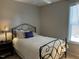 Charming bedroom with a wrought iron bed frame, soft lighting, and a bright window at 12409 Angel Vale Pl, Durham, NC 27703